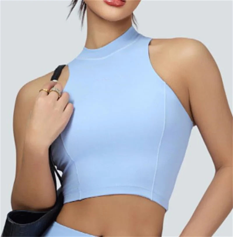 Light blue vest crop top and skort set by Xooie Fit featuring a sleeveless high neck design