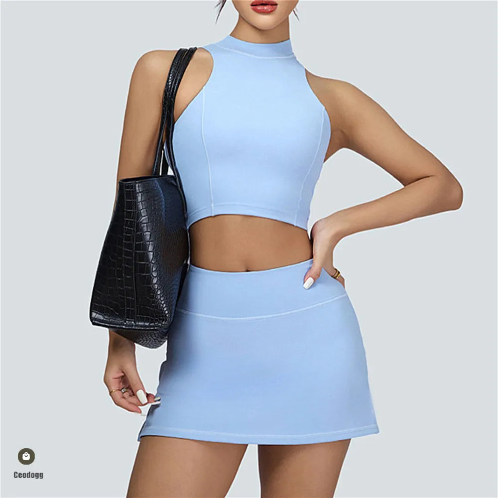 Xooie Fit light blue vest crop top and skort set worn with black handbag for casual style