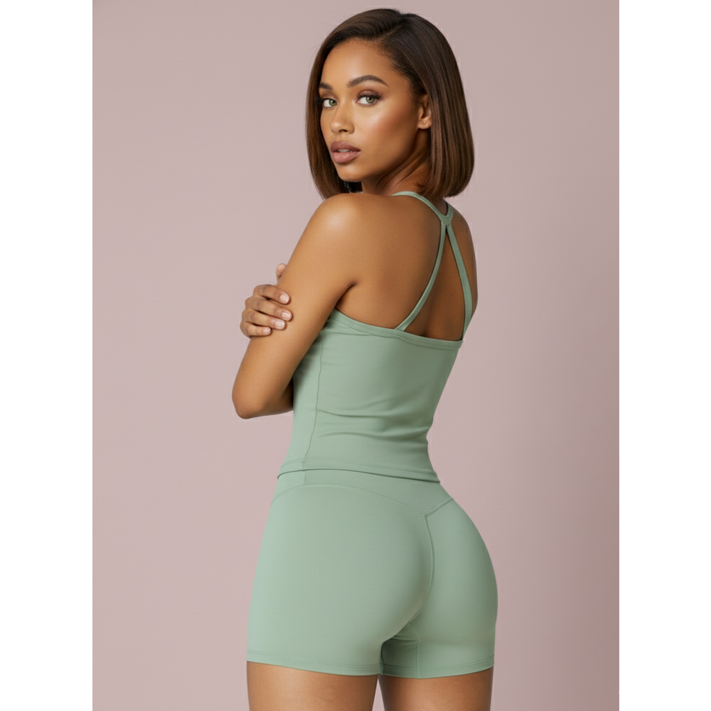 Woman wearing a green sports outfit against a beige background