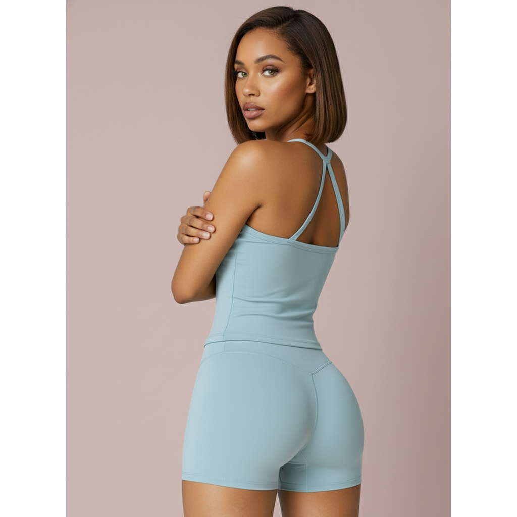 Woman wearing a light blue jumpsuit against a beige background