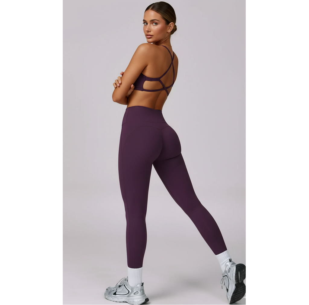 Woman wearing a purple athletic outfit on a light gray background