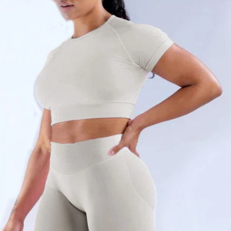Xooie Fit women's fitted activewear set in light beige featuring a cropped top and high-waisted leggings