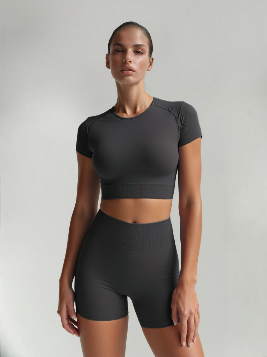 Xooie Fit women's fitted activewear set in dark gray featuring a cropped top and matching shorts