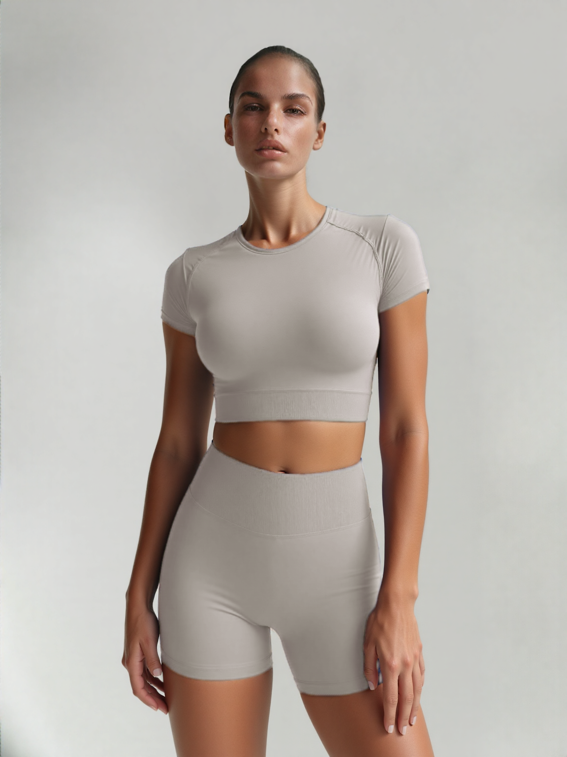 Xooie Fit women's fitted activewear set in light grey, featuring a cropped top and matching shorts
