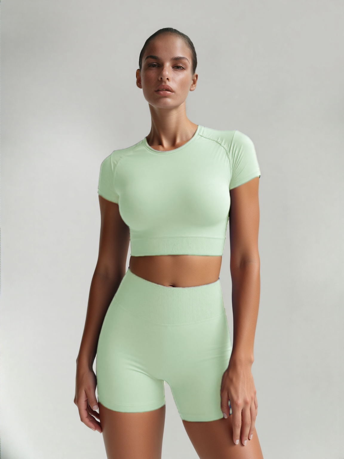 Xooie Fit women's fitted activewear set in mint green featuring a crop top and high-waisted shorts