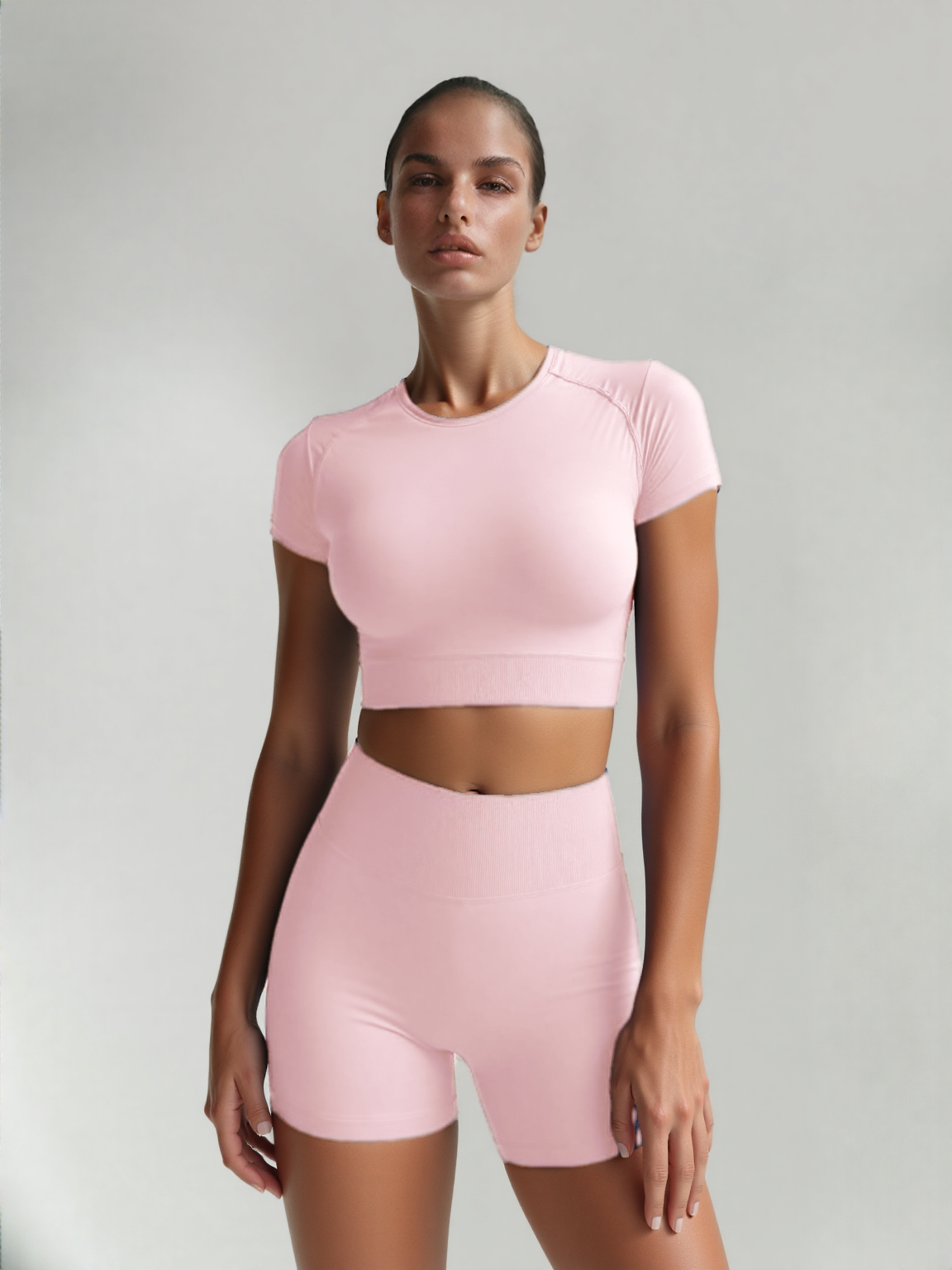 Xooie Fit women's fitted activewear set in pink featuring a cropped top and matching shorts