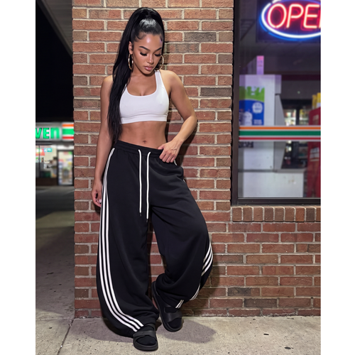 Black oversized wide-leg sweatpants with drawstring and white side stripe accents