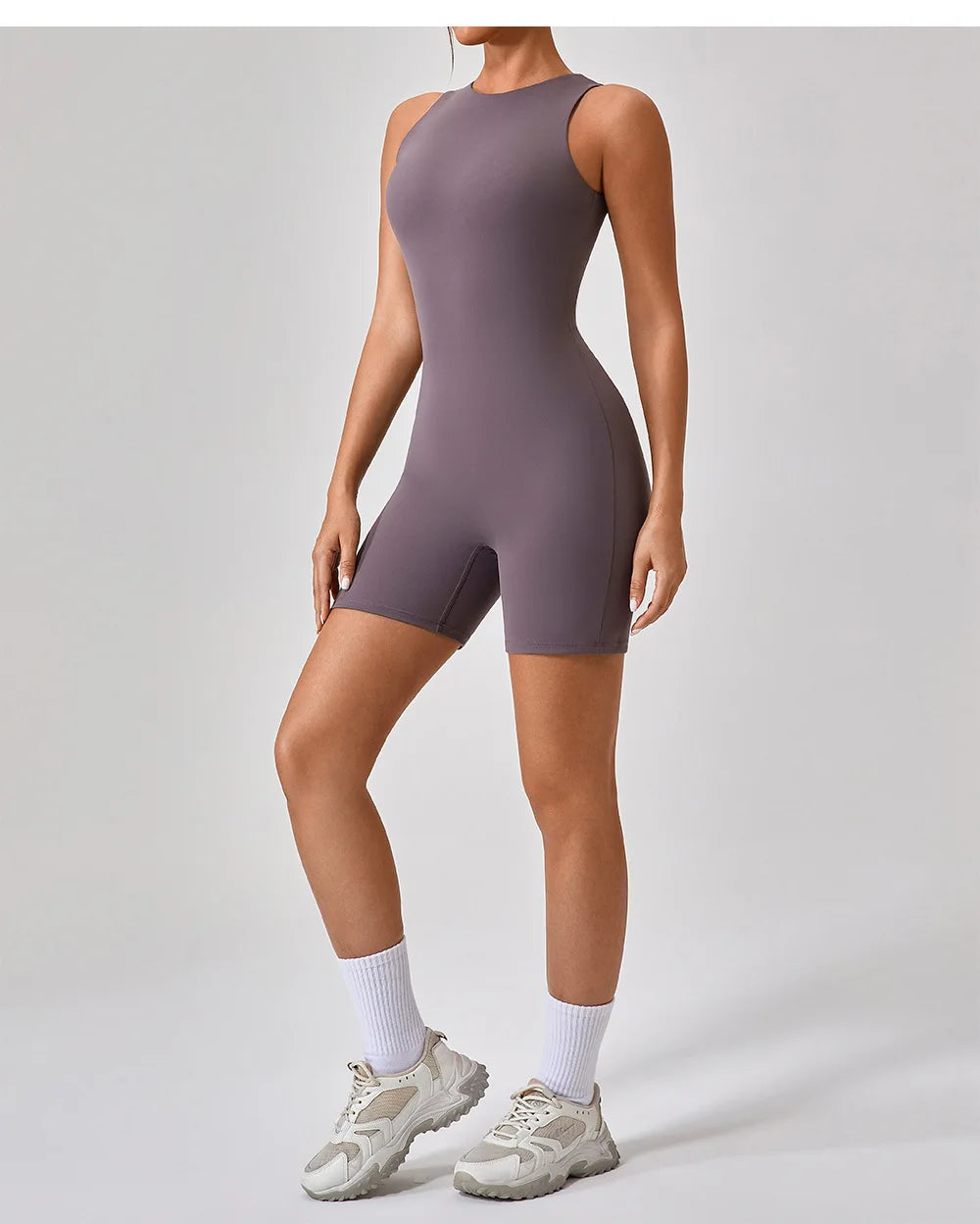 Purple active romper, sleeveless one-piece with racerback and short leg.
