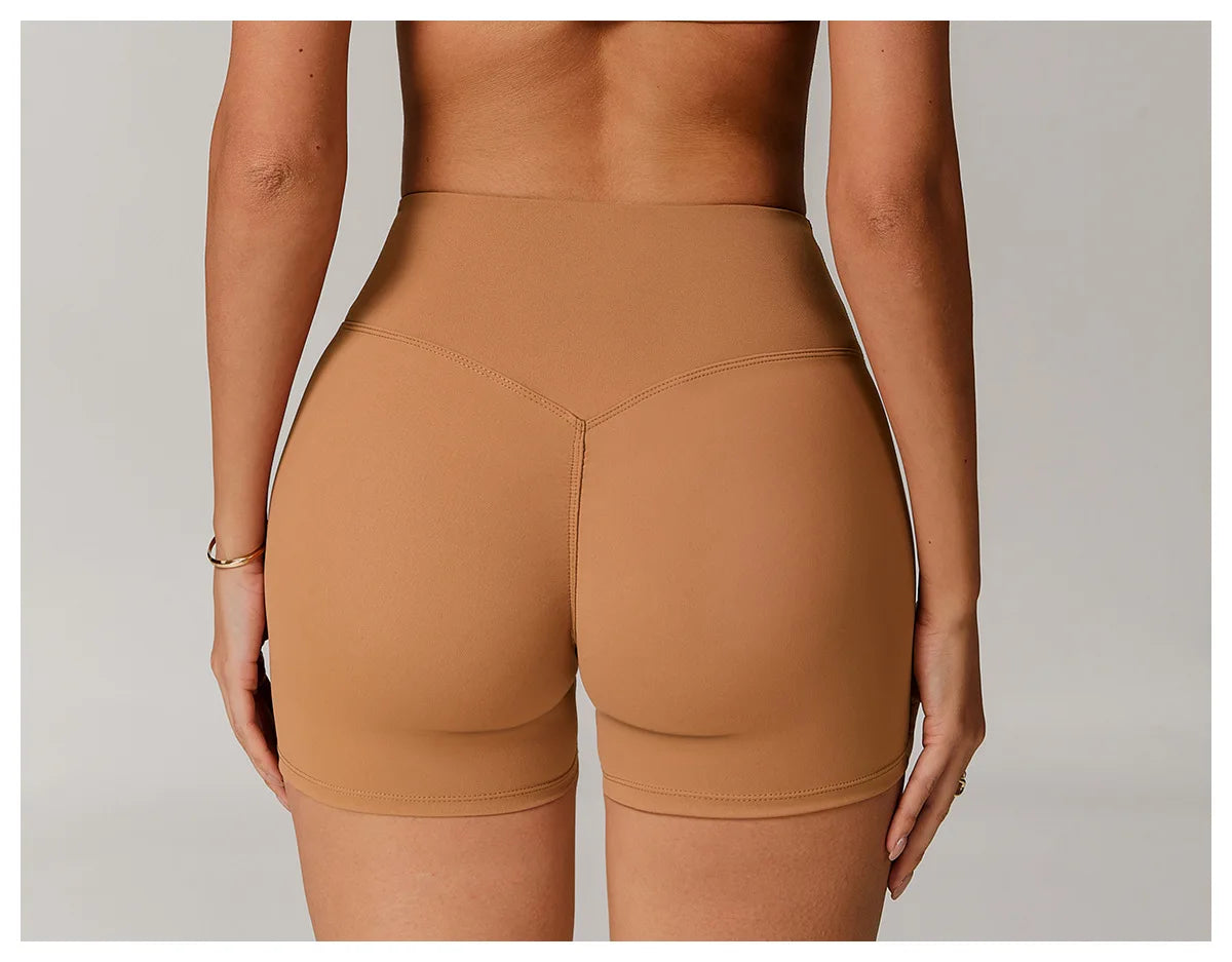 Xooie Fit women's active shorts in tan color showing back view with high waist design