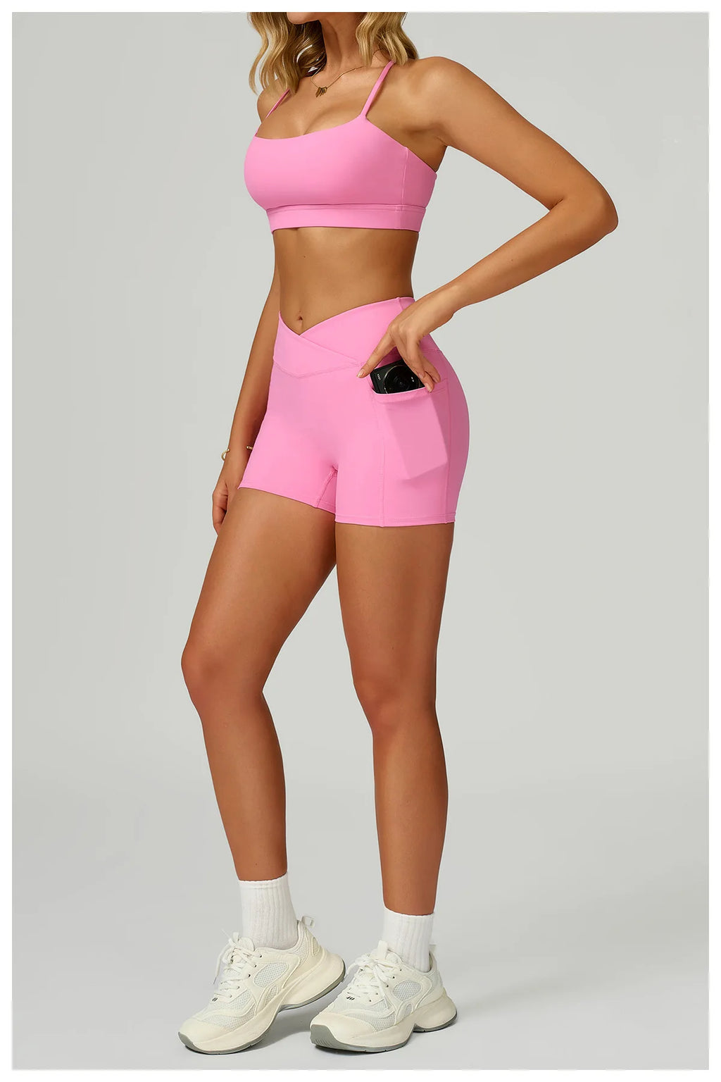 Pink side view of X-back bralette and matching shorts with pockets