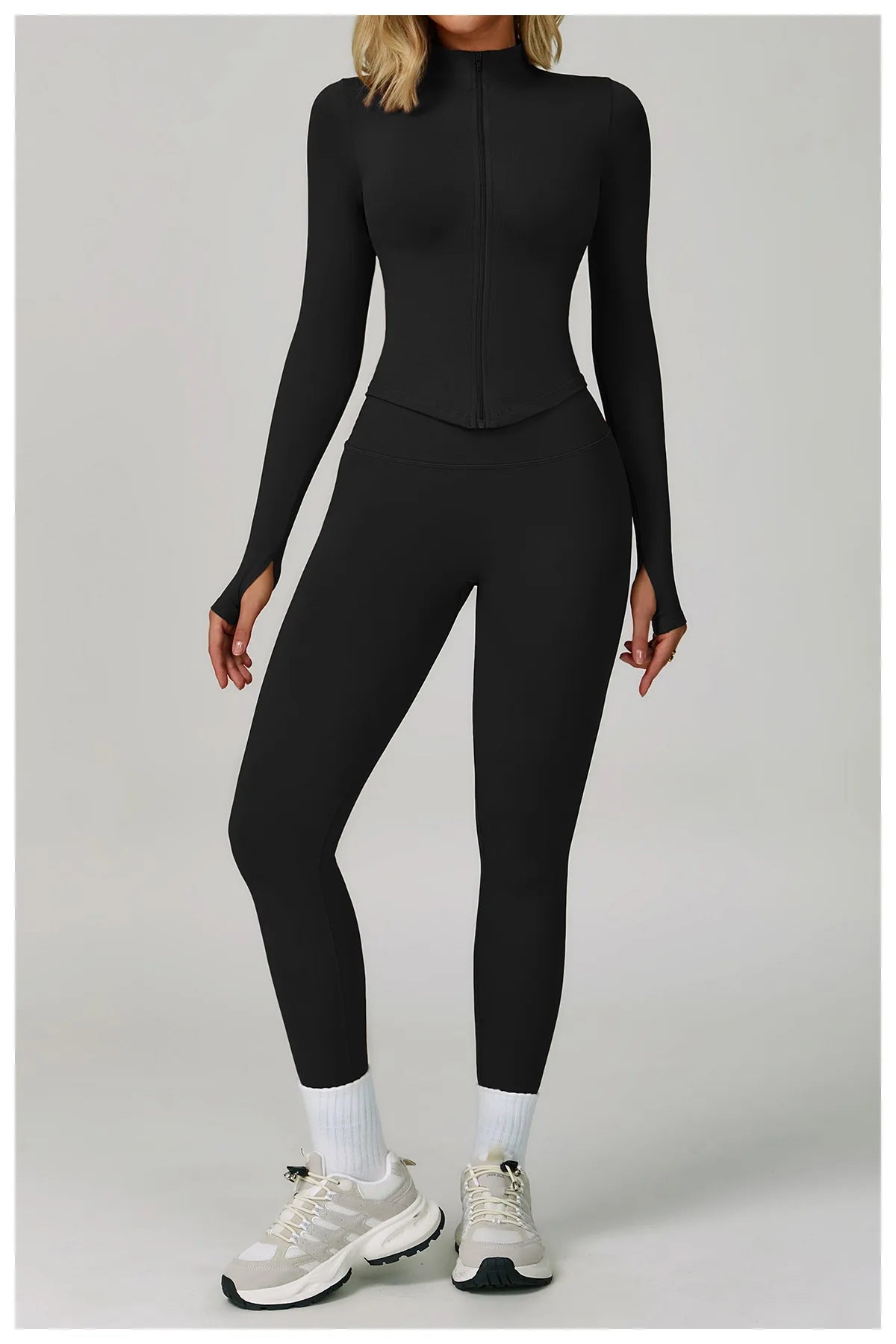 Xooie Fit women's activewear matching set in black, featuring a zip-up top and fitted leggings