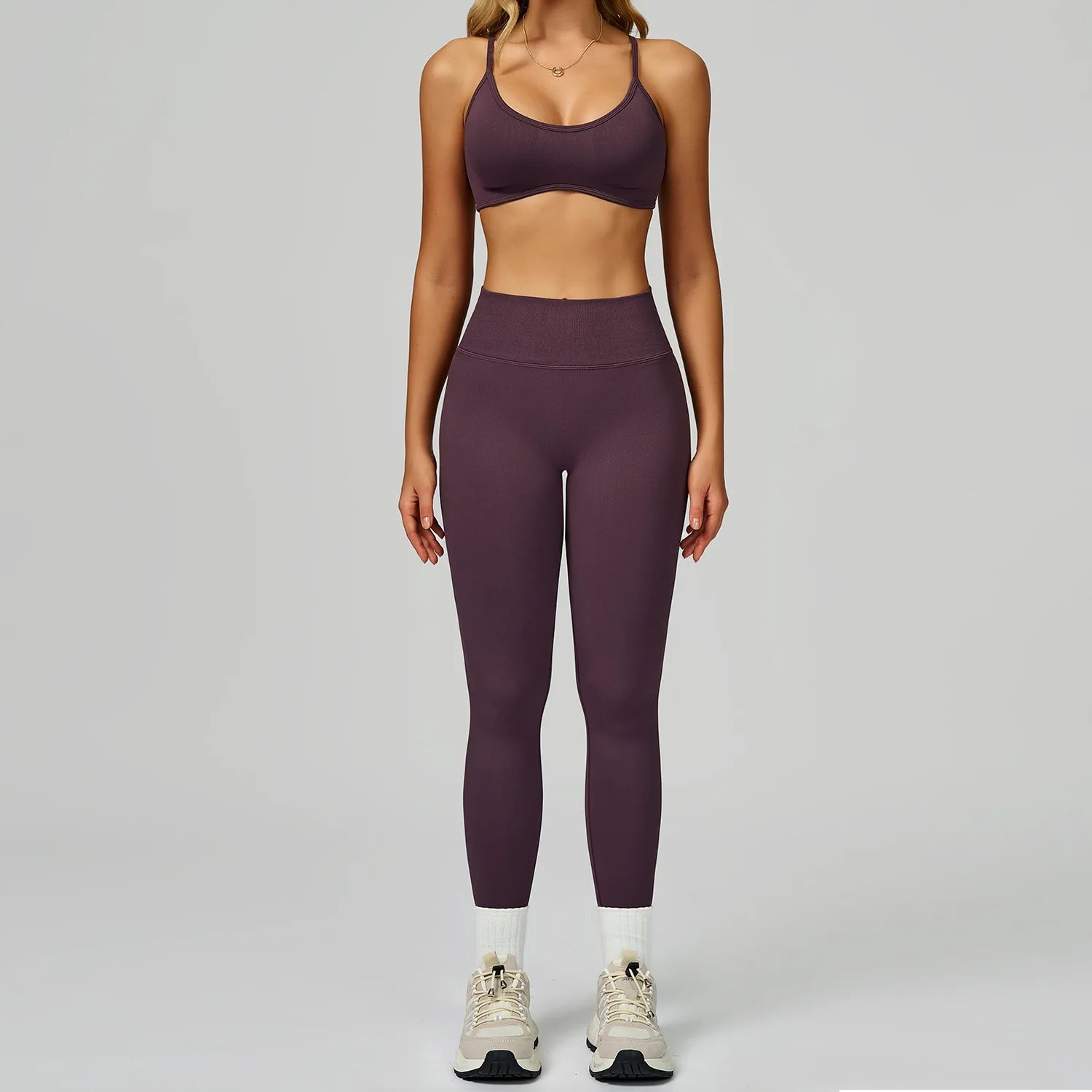 Xooie Fit women's activewear matching set in dark purple featuring a sports bra and high-waisted leggings