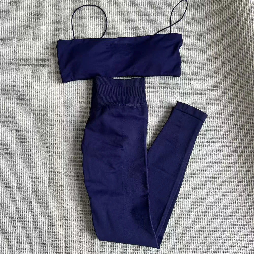 Navy blue thin strap bra and high-waisted leggings set, laid flat