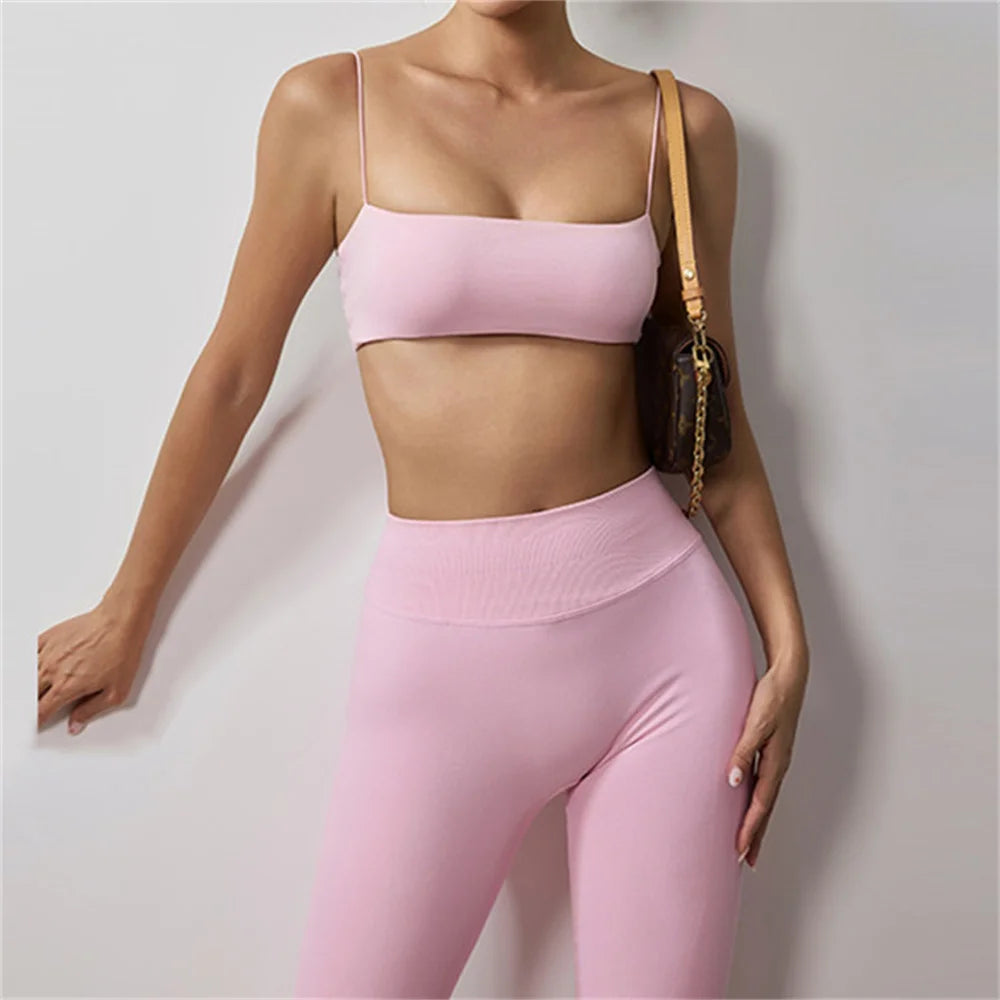 Pink thin strap bra and high-waisted leggings active set, close-up