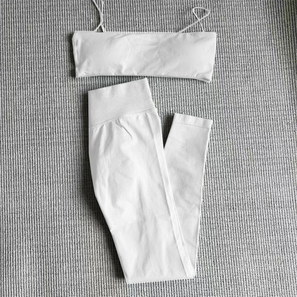 White bandeau-style sports top and high-waisted leggings matching set, folded