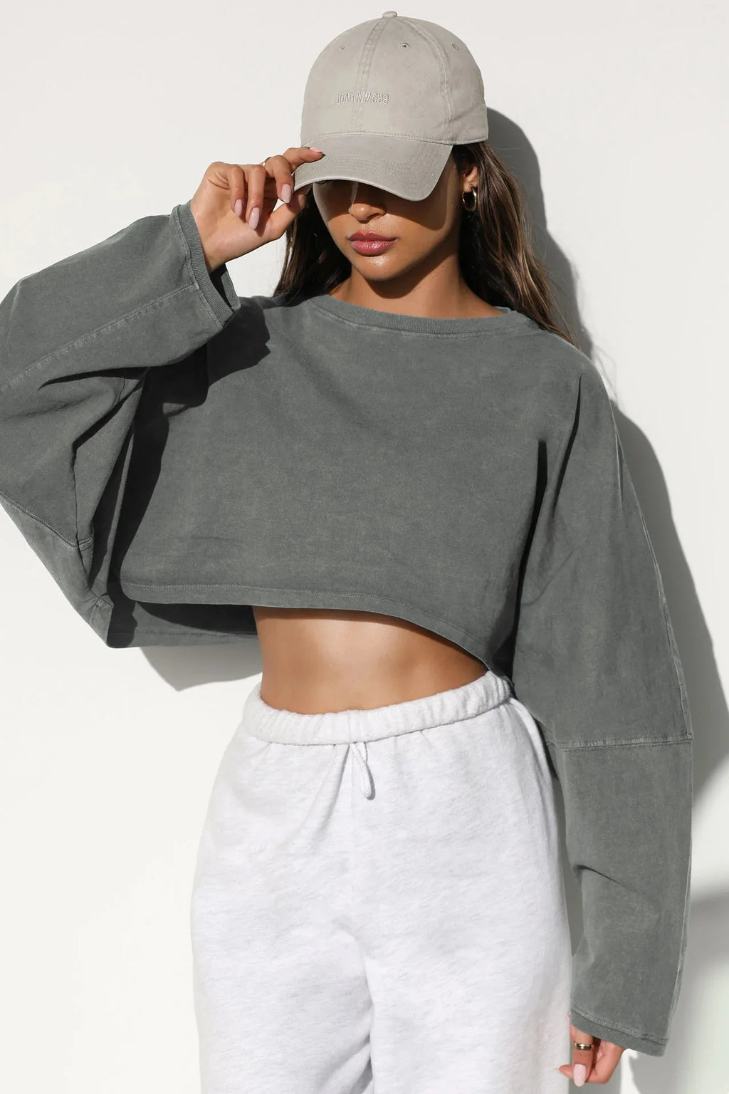 Xooie Fit women's baggy crop top in gray with long sleeves, styled with casual pants and a hat