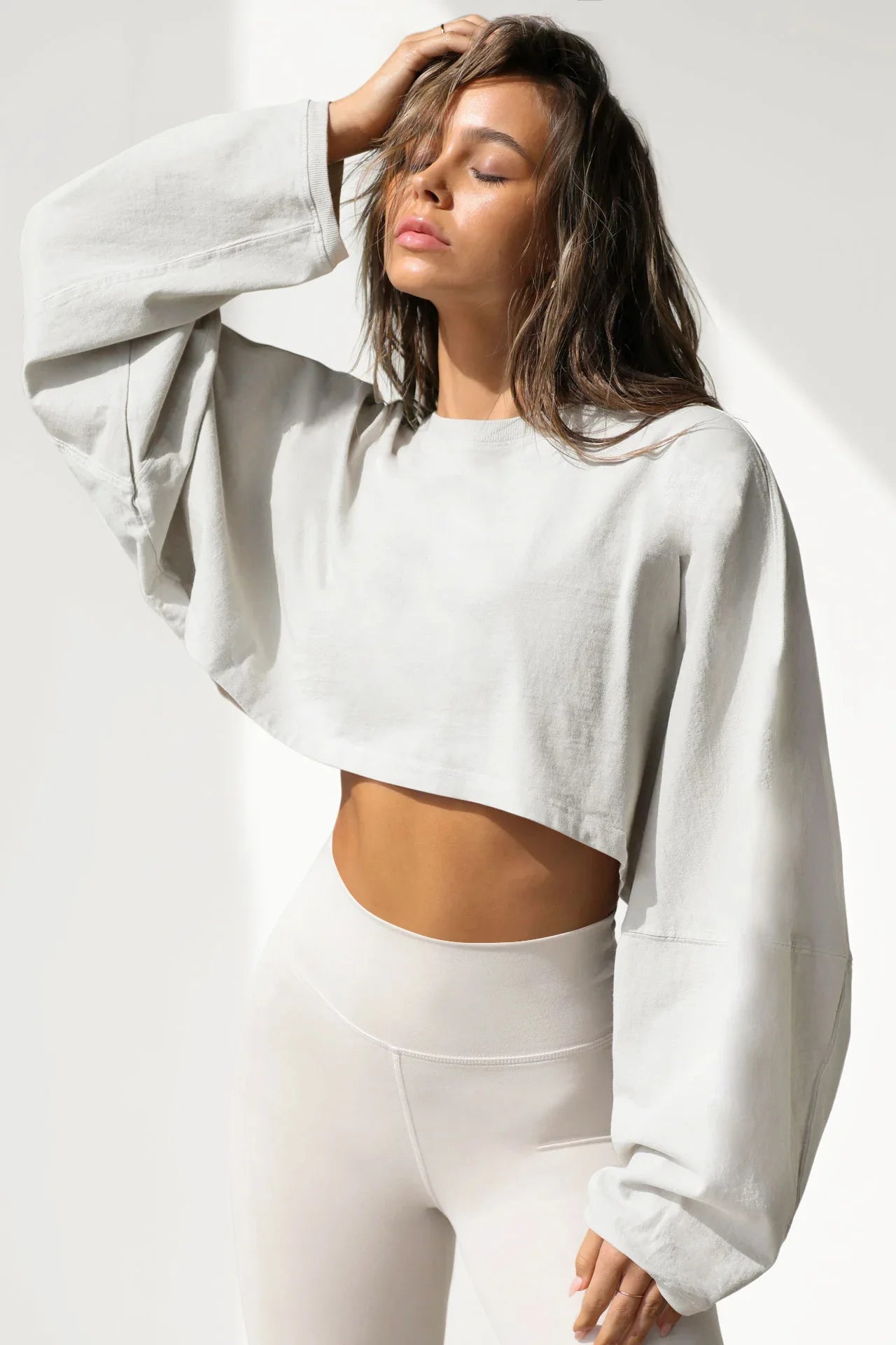 Xooie Fit women's baggy crop top in light gray paired with high-waisted leggings