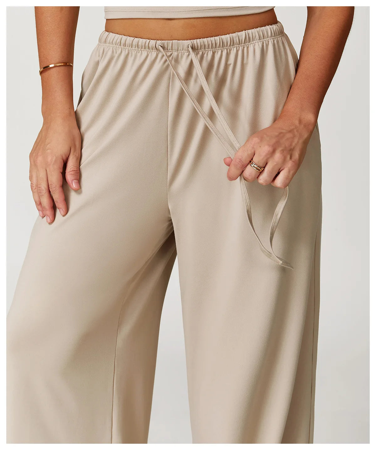 Xooie Fit women's baggy workout pants in beige with a comfortable elastic waistband and adjustable drawstring