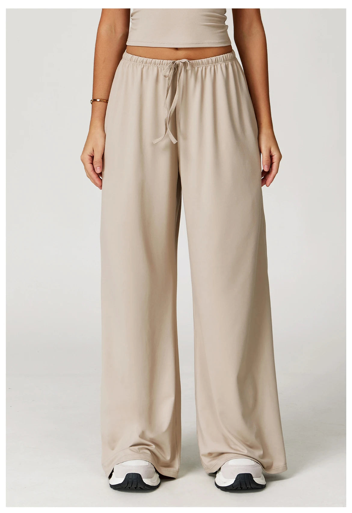 Xooie Fit women's baggy workout pants in beige with a comfortable elastic waistband and side pockets