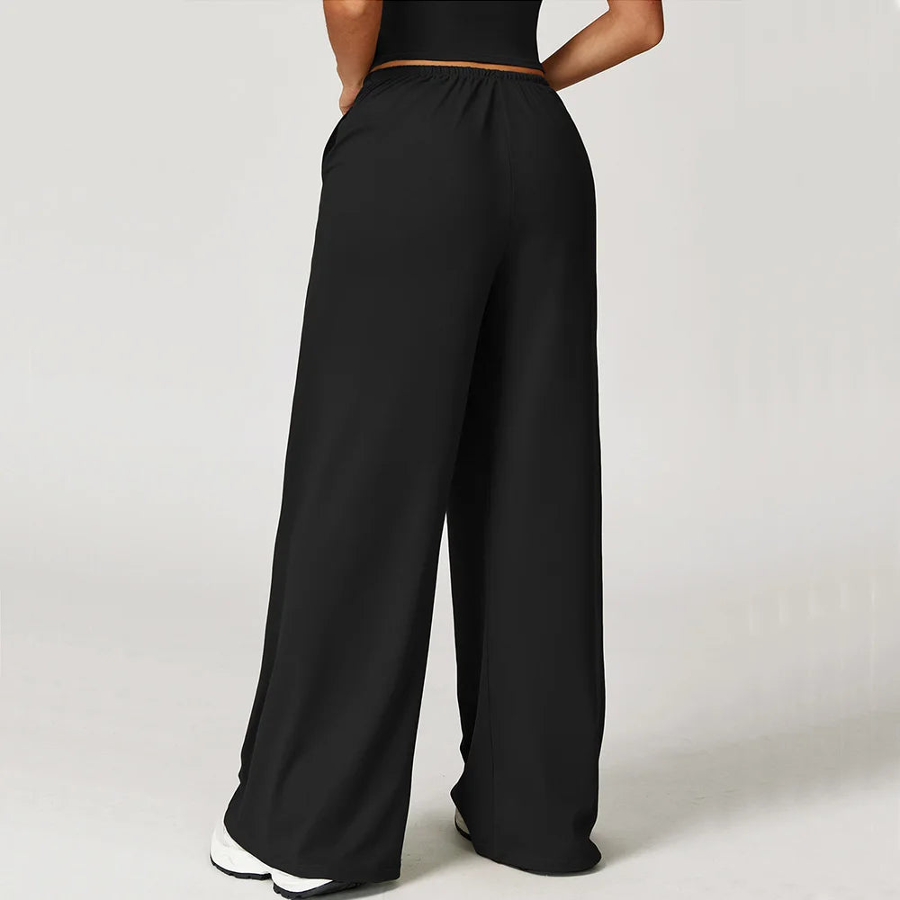 Back view of Xooie Fit women's baggy workout pants in black with comfortable elastic waistband