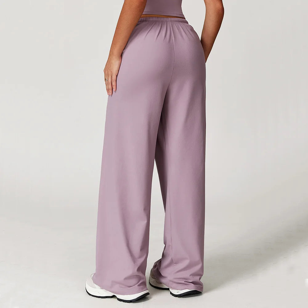 Women's baggy workout pants in lavender color with elastic waistband for comfortable exercise