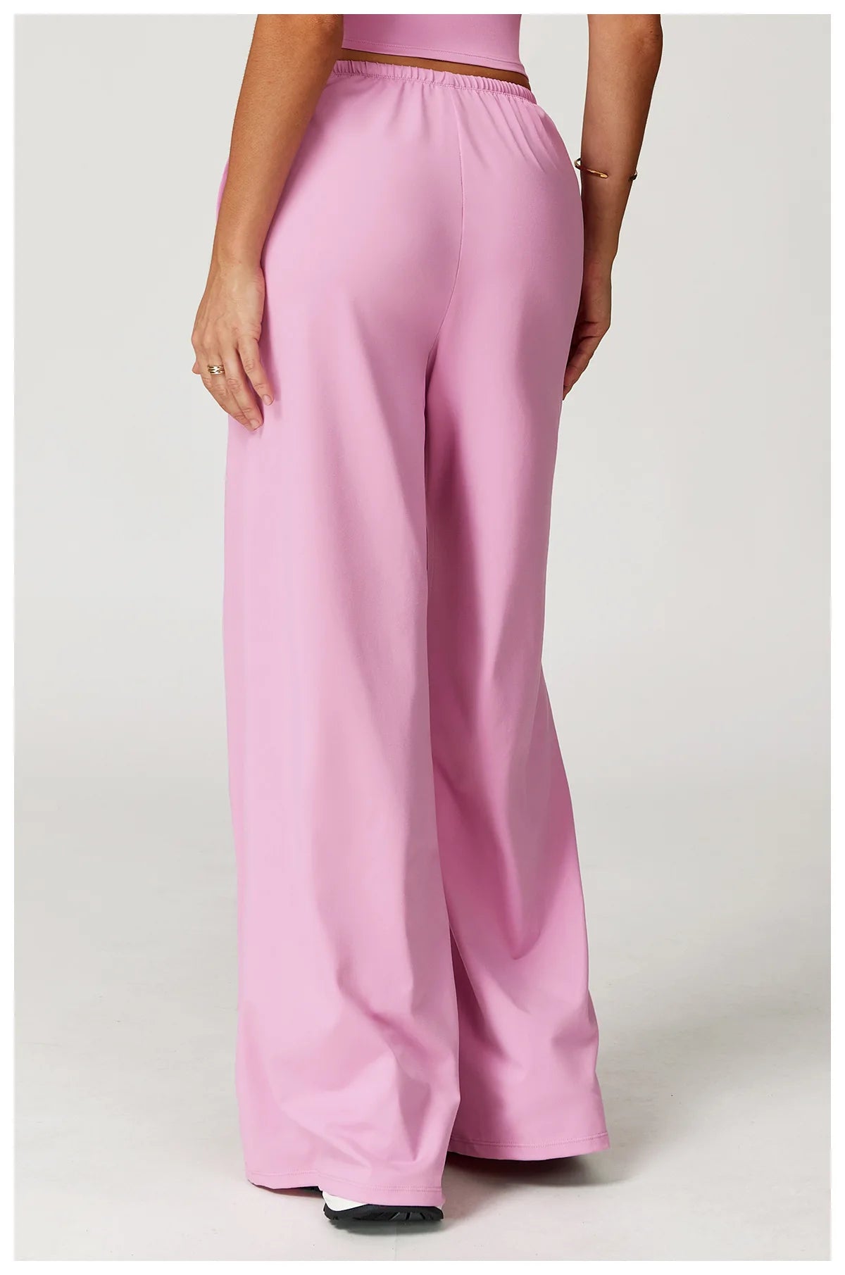 Back view of Xooie Fit women's baggy workout pants in pink, offering comfort and style for workouts