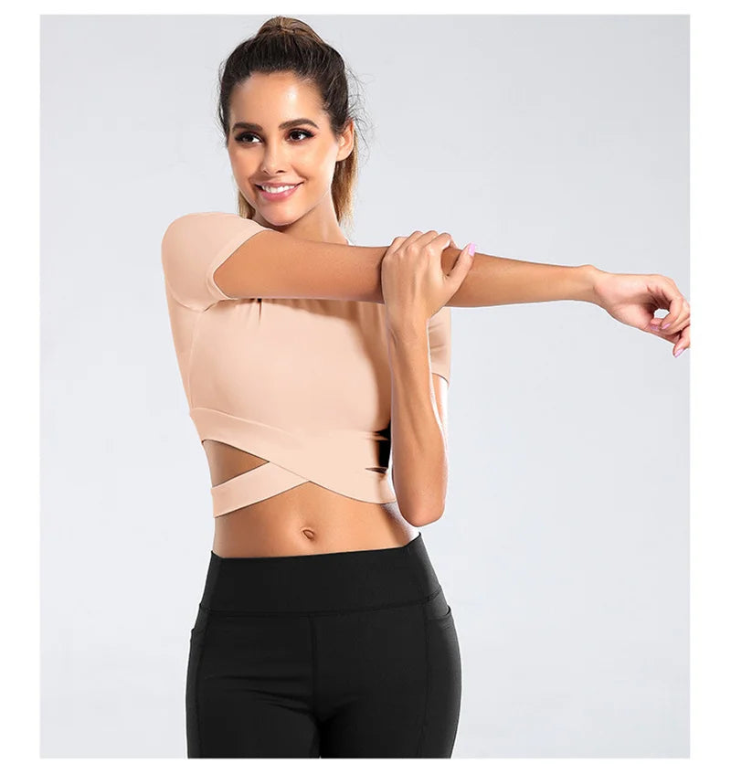 Xooie Fit women's criss-cross crop top in nude with short sleeves, perfect for workouts and casual wear
