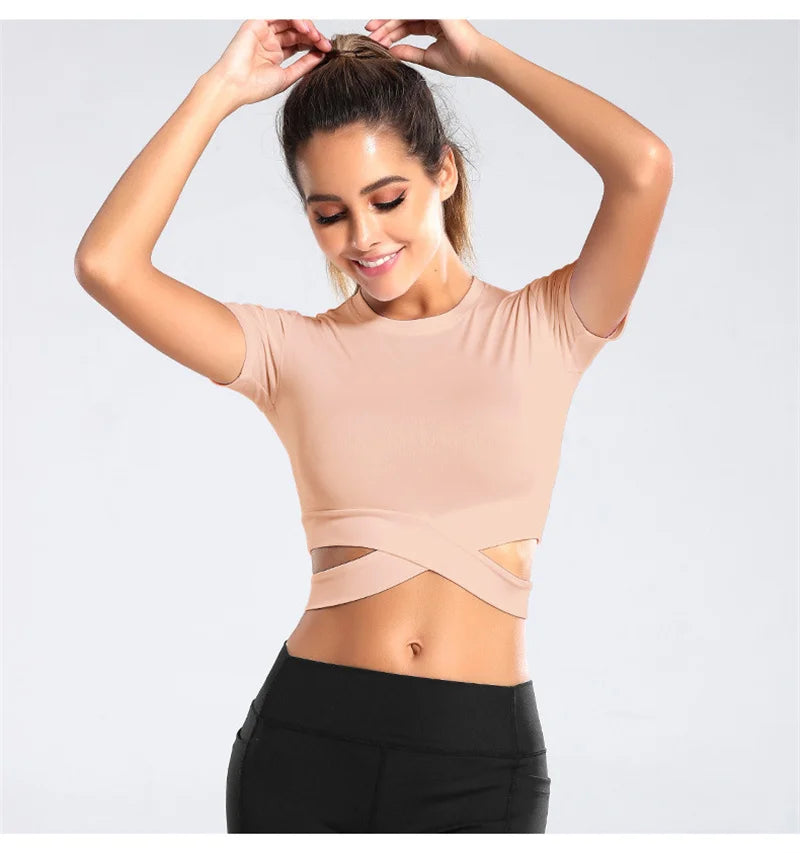 Xooie Fit women's criss-cross crop top in nude color with short sleeves and stylish cut-out design