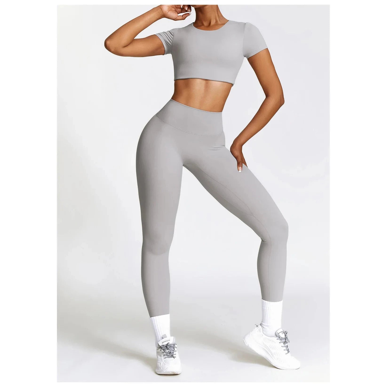 Stylish Xooie Fit women's fitness clothing set in gray featuring a crop top and high-waisted leggings
