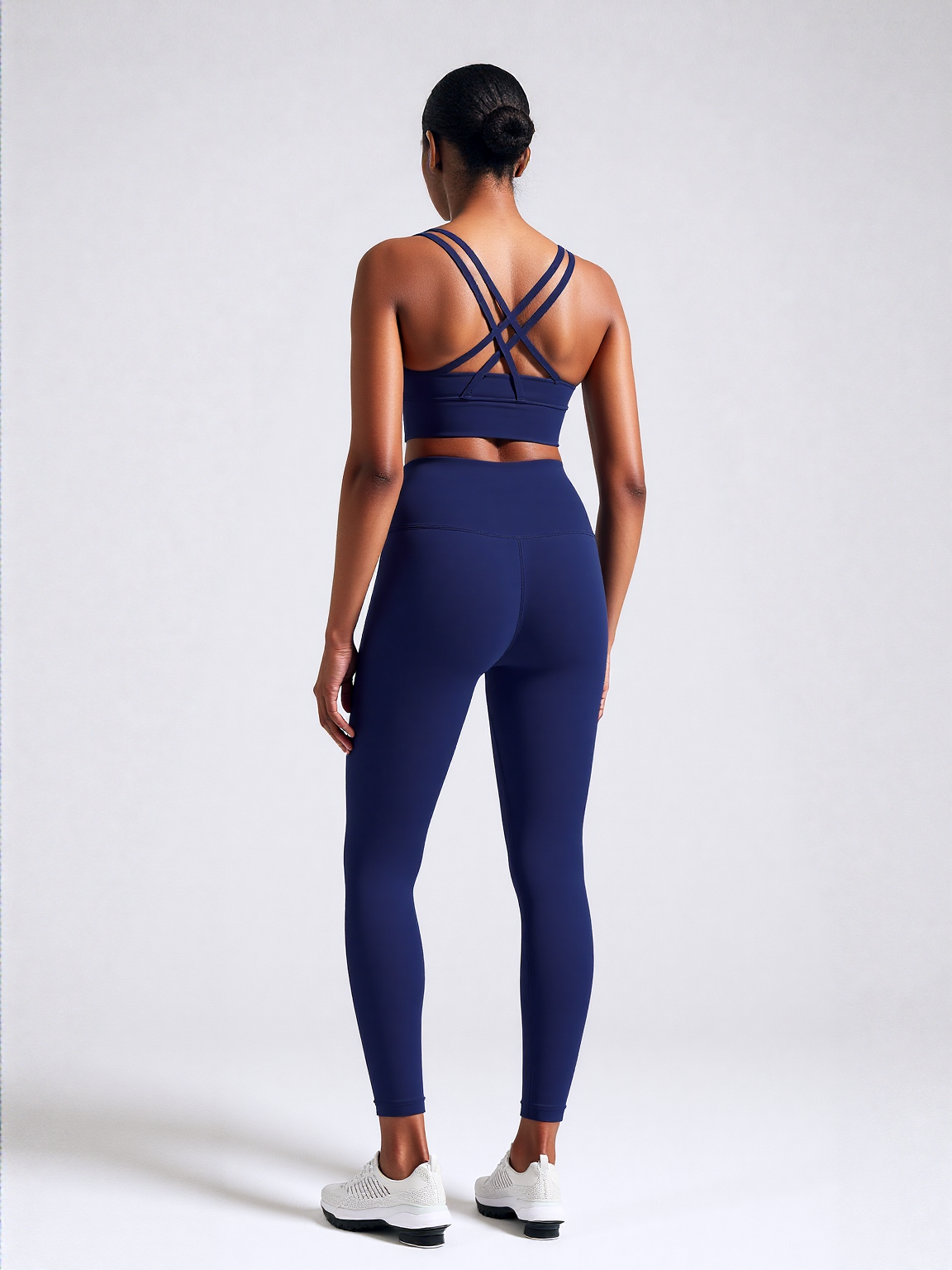 Xooie Fit women's fitness clothing set in navy with stylish crisscross back design and high-waisted leggings
