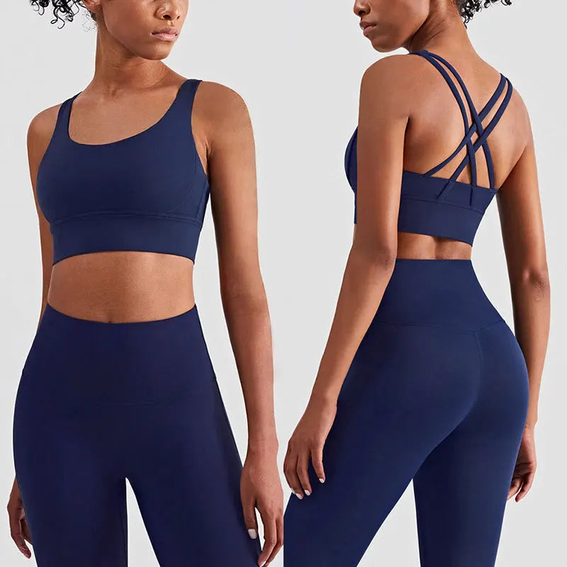 Navy Xooie Fit women's fitness clothing set featuring a strappy sports bra and high-waisted leggings