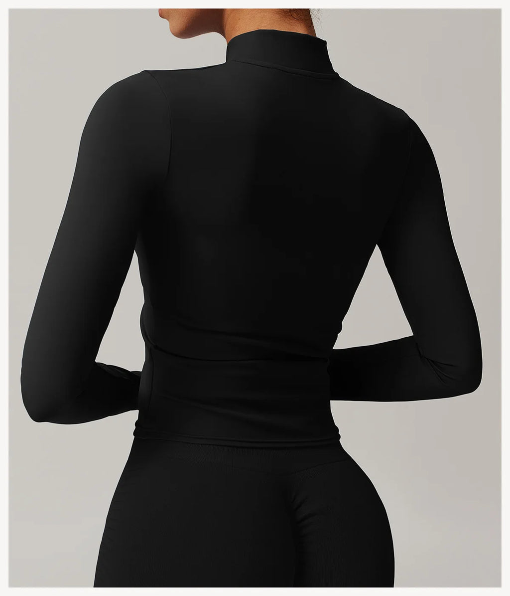 Back view of black women's fitness jacket with thumb holes by Xooie Fit featuring a sleek, fitted design