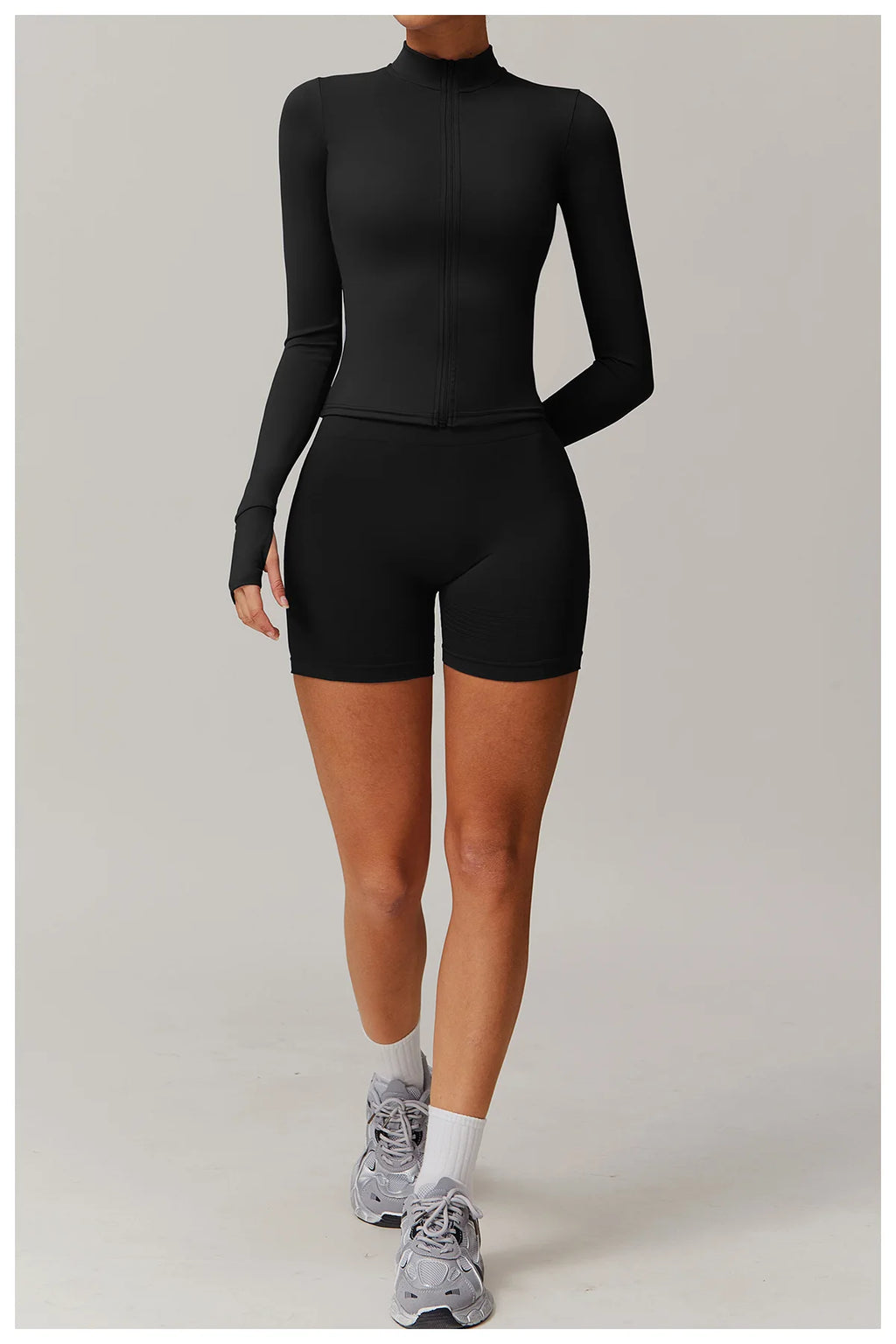 Xooie Fit women's fitness jacket with thumb holes in black, paired with matching black shorts