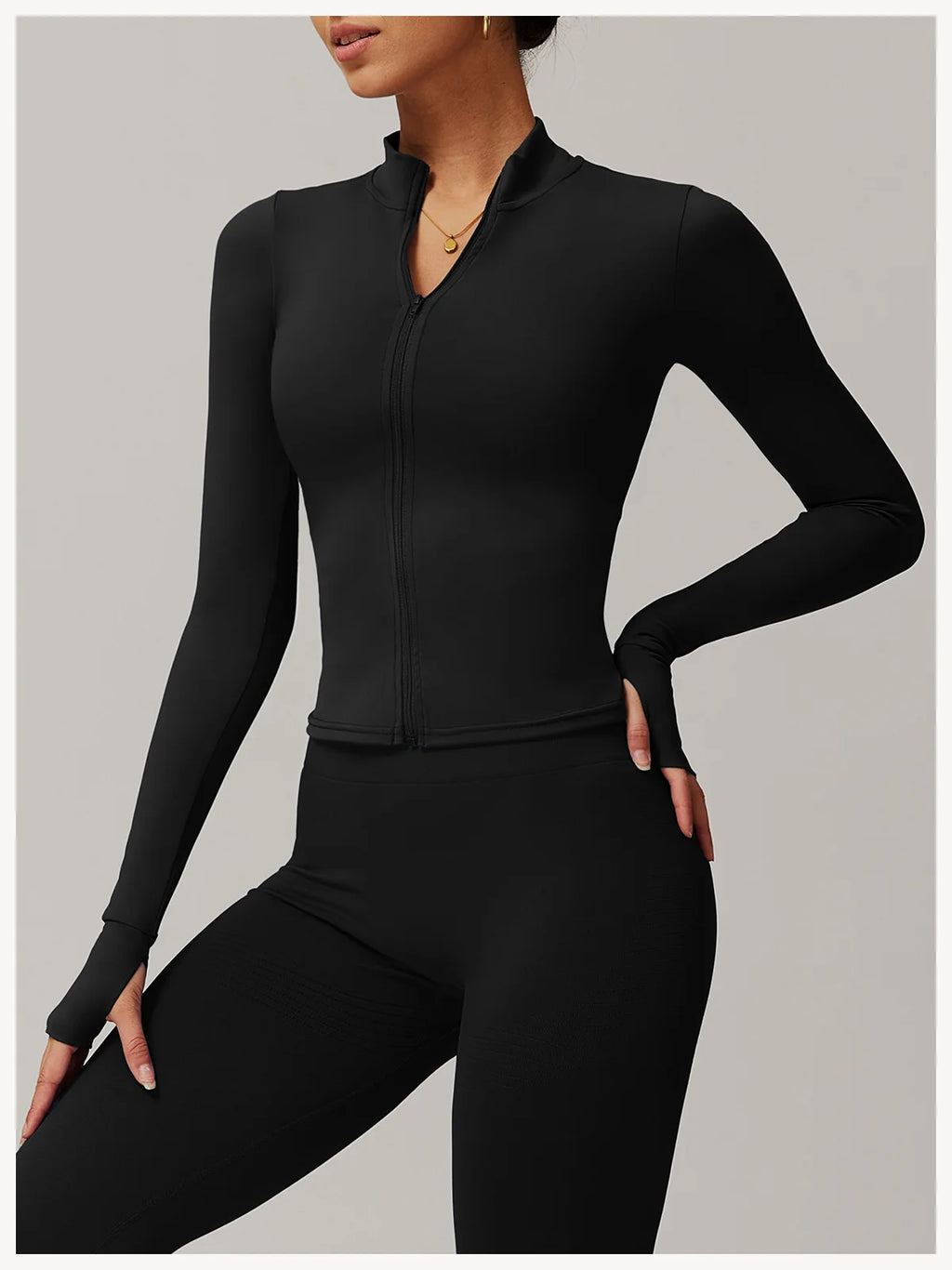 Xooie Fit black women's fitness jacket with thumb holes and front zipper for active wear