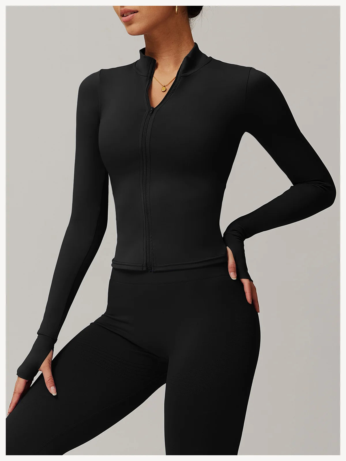 Xooie Fit black women's fitness jacket with thumb holes and front zipper for active wear