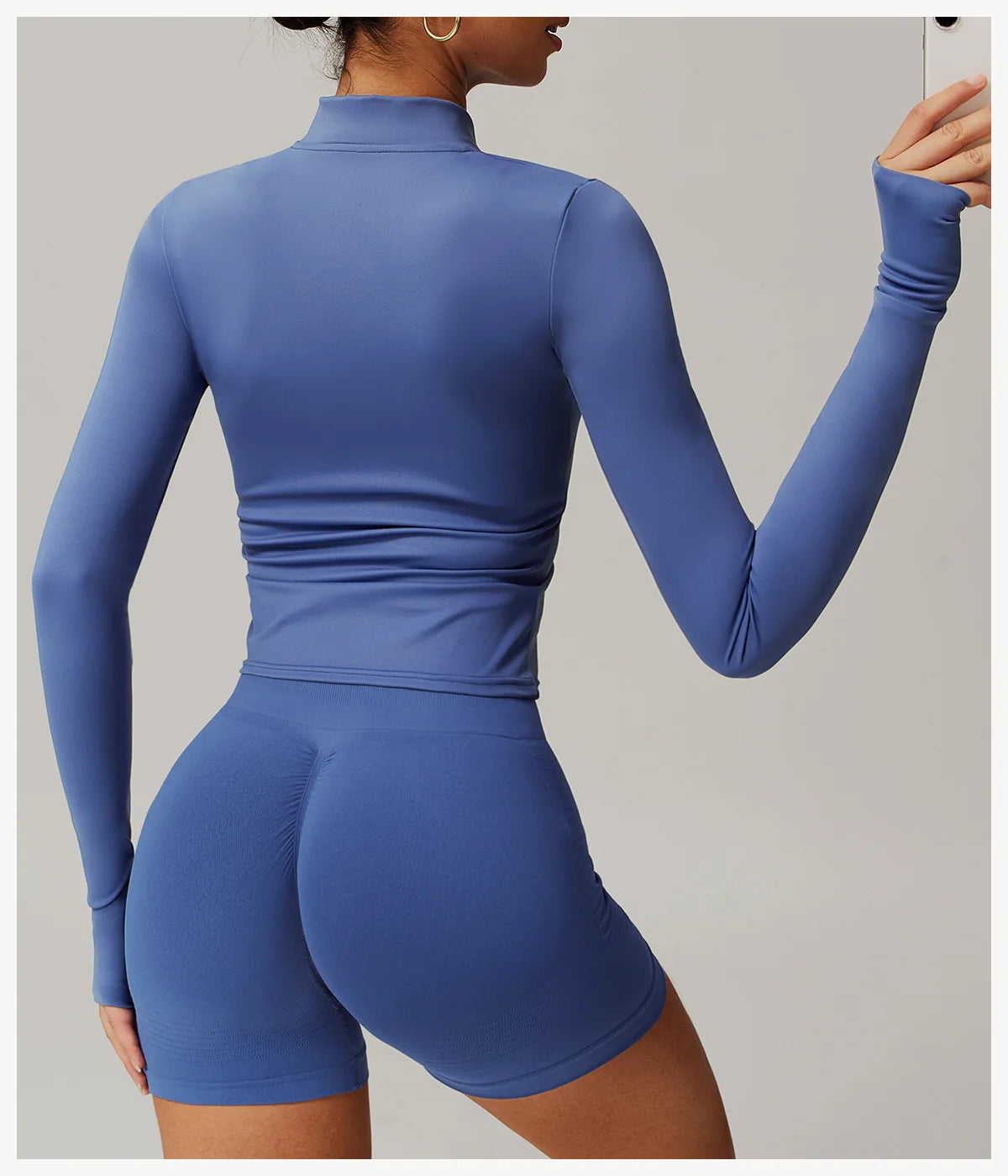 Xooie Fit women's fitness jacket with thumb holes in blue fitted style shown from back