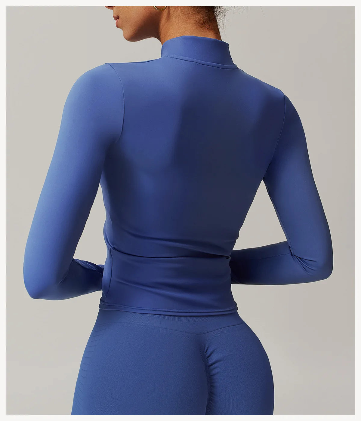 Xooie Fit women's fitness jacket with thumb holes in fitted blue fabric shown from back