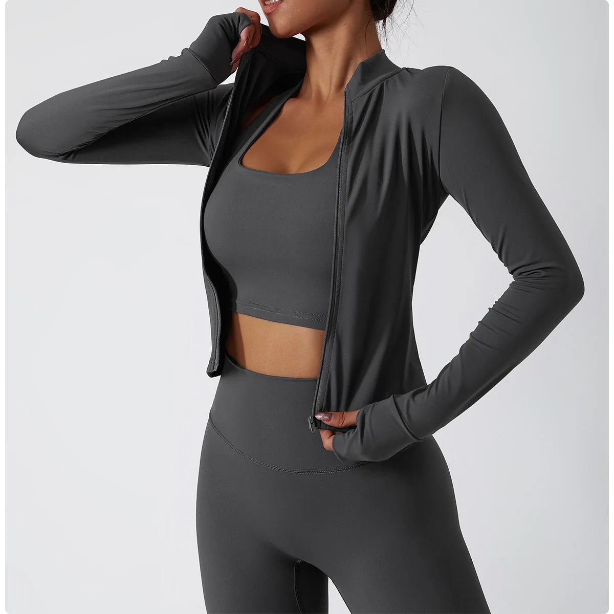 Xooie Fit women's fitness jacket with thumb holes in grey, paired with matching grey shorts