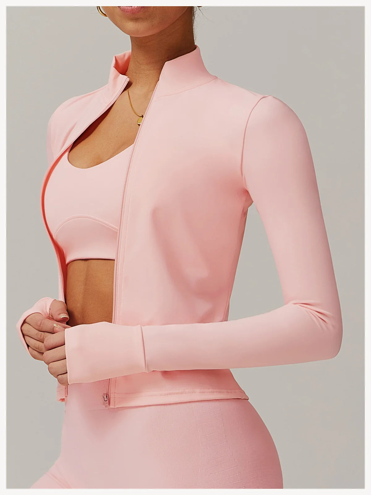 Xooie Fit women's fitness jacket with thumb holes in light pink with full zip and slim fit design