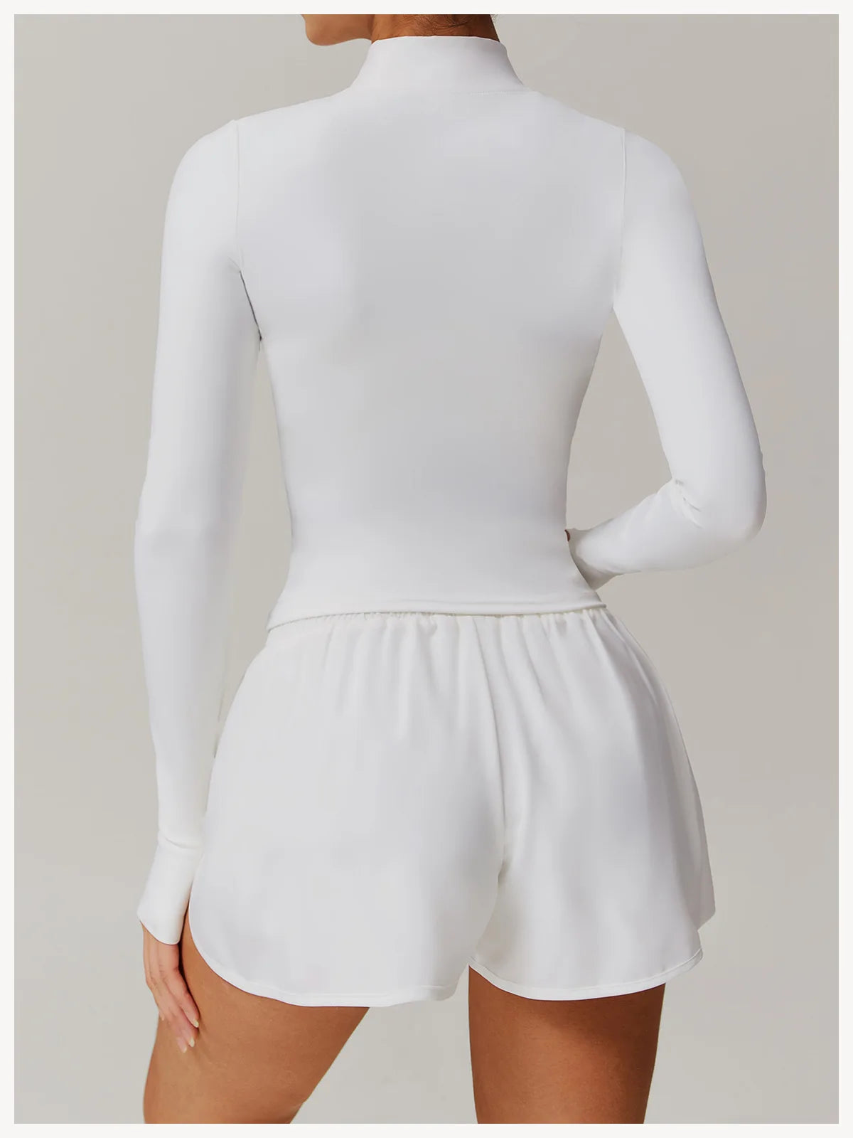 Xooie Fit women's fitness jacket with thumb holes in white long sleeve slim fit design