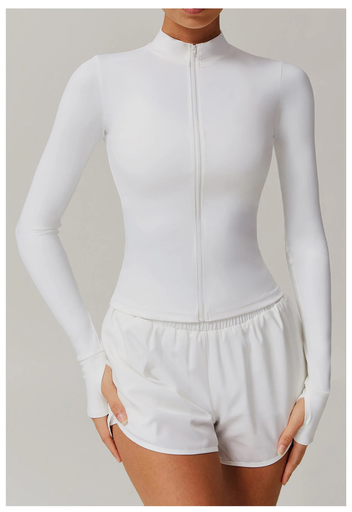 Xooie Fit women's fitness jacket with thumb holes in white, full-zip, long sleeve activewear