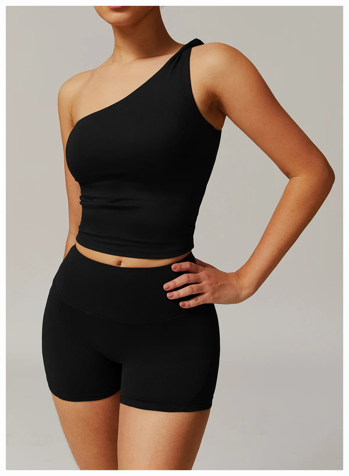 Xooie Fit black two-piece women's fitness matching set with one-shoulder top and high-waisted shorts