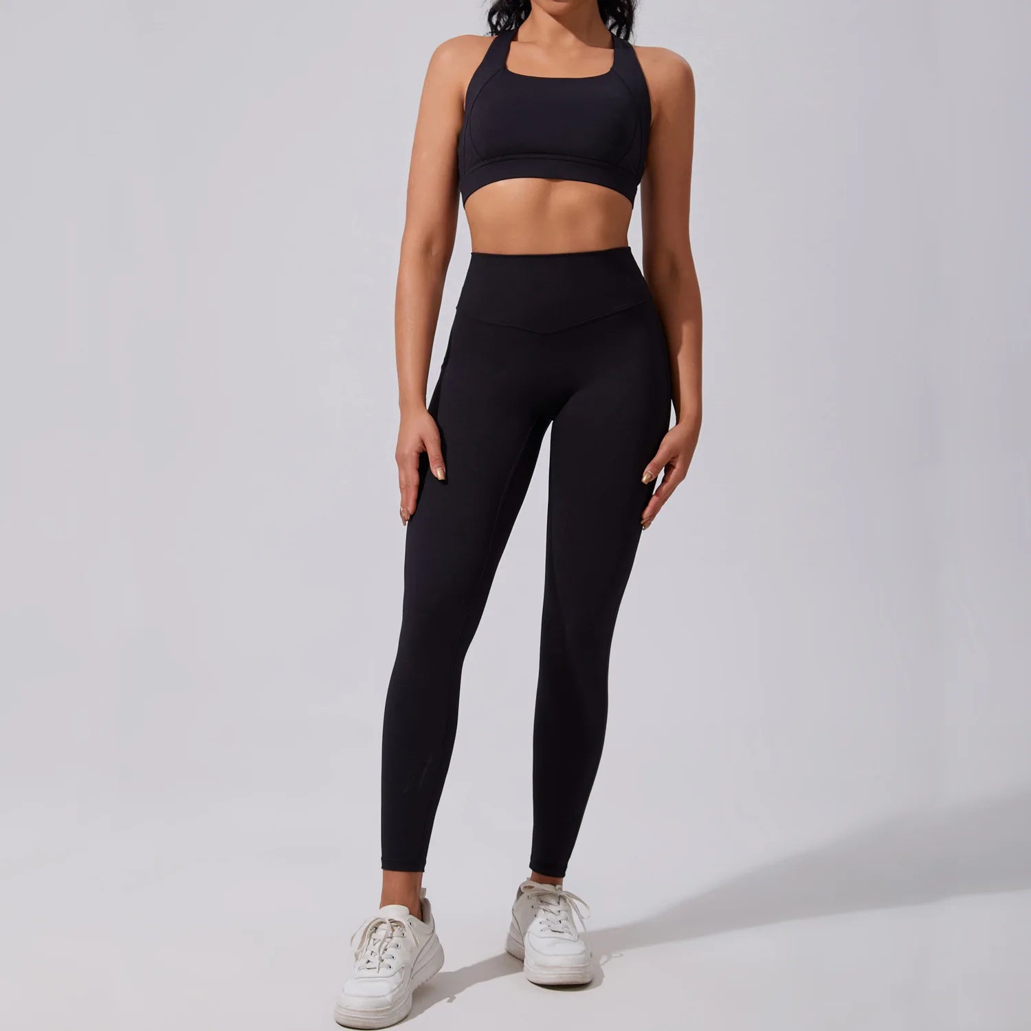 Xooie Fit women's fitness matching set in black featuring a crop top and high-waisted leggings