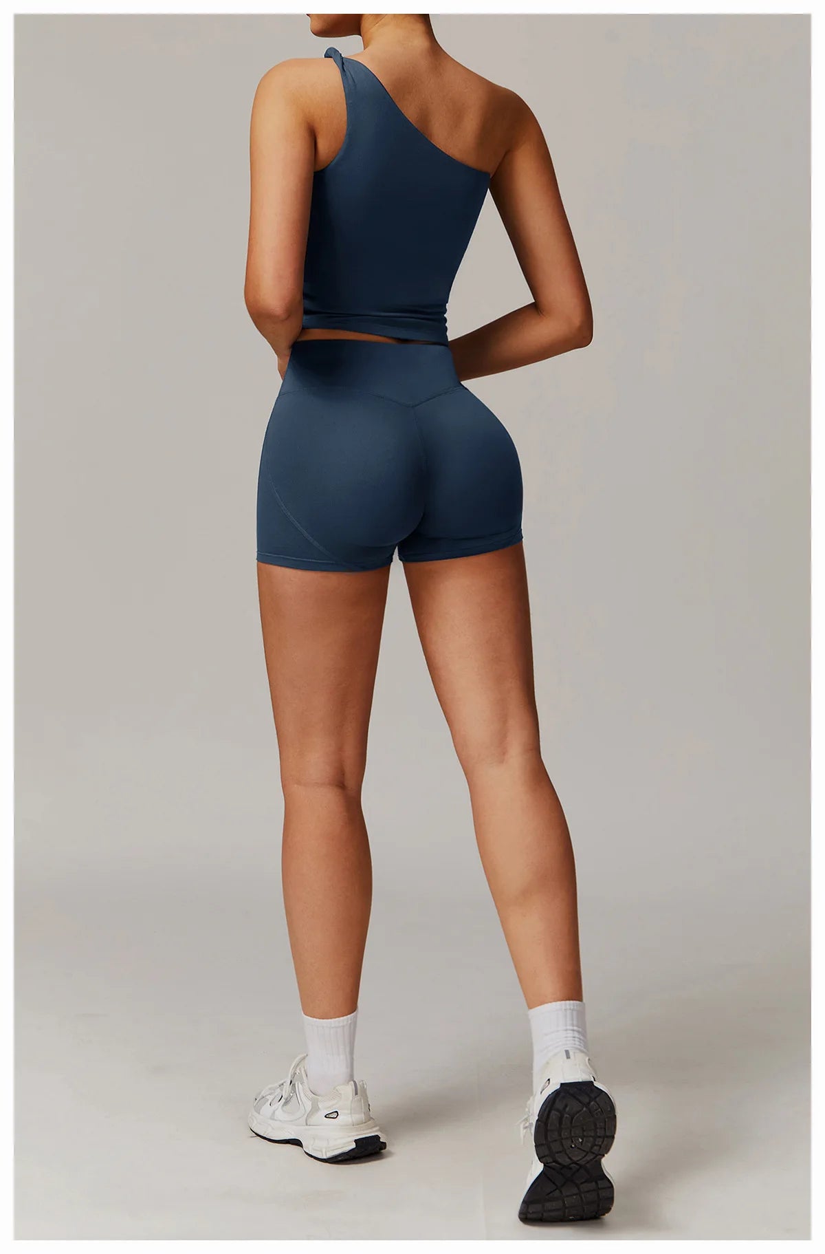 Xooie Fit women's fitness matching set with one-shoulder crop top and high-waisted shorts in navy blue