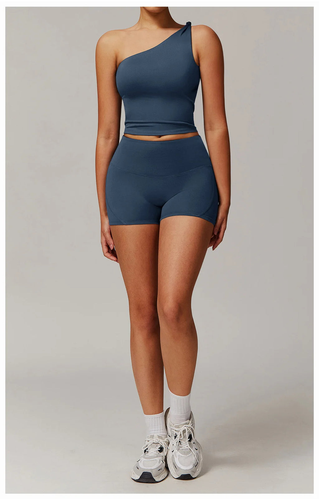 Xooie Fit women's fitness matching set in navy blue featuring one-shoulder crop top and high-waisted shorts