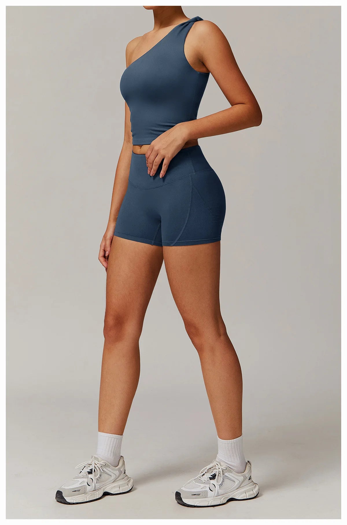 Xooie Fit women's fitness matching set with one-shoulder crop top and high-waisted shorts in blue