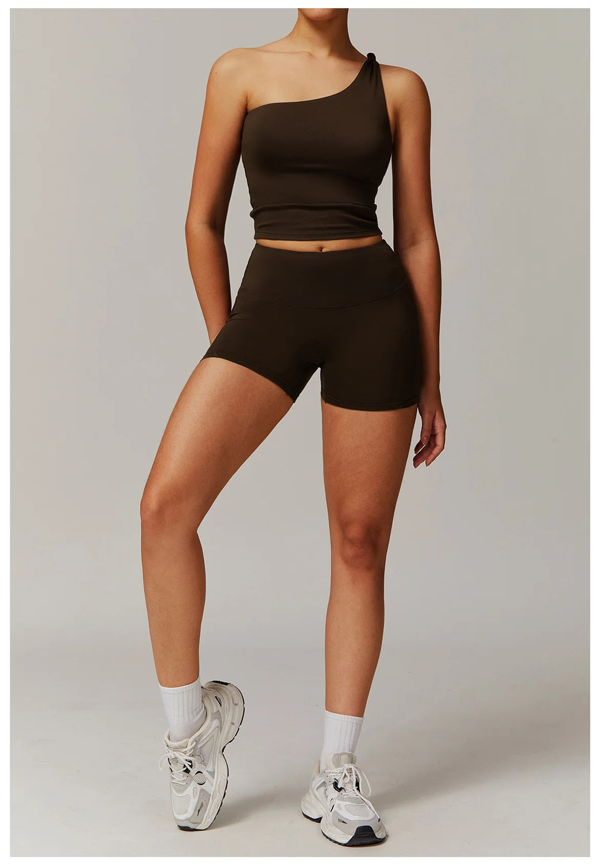 Xooie Fit women's fitness matching set featuring a one-shoulder crop top and high-waisted shorts in black