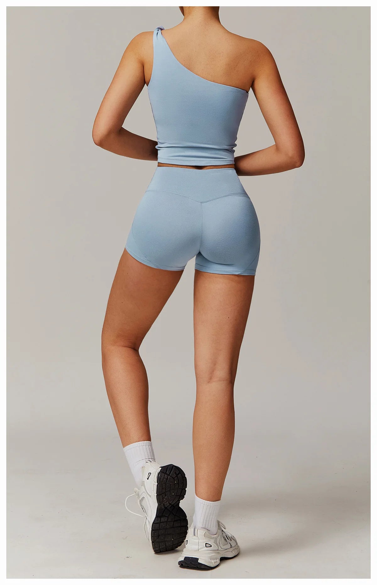 Xooie Fit women's fitness matching set in light blue with one-shoulder top and high-waisted shorts2