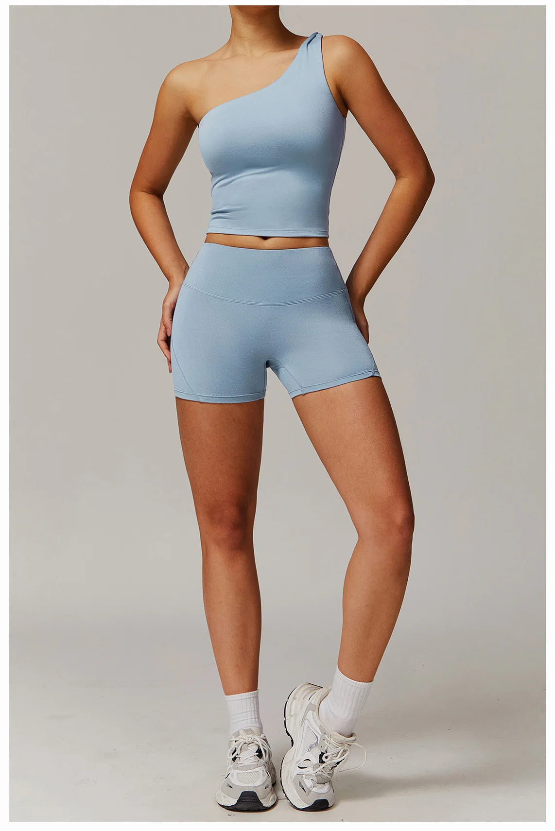 Xooie Fit women's fitness matching set in light blue with one-shoulder top and high-waisted shorts