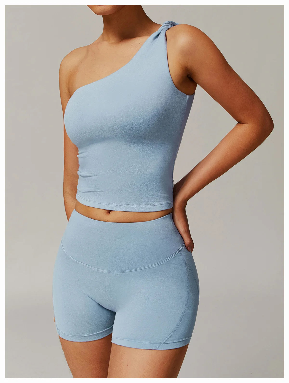 Xooie Fit light blue women's fitness matching set with one-shoulder top and high-waisted shorts